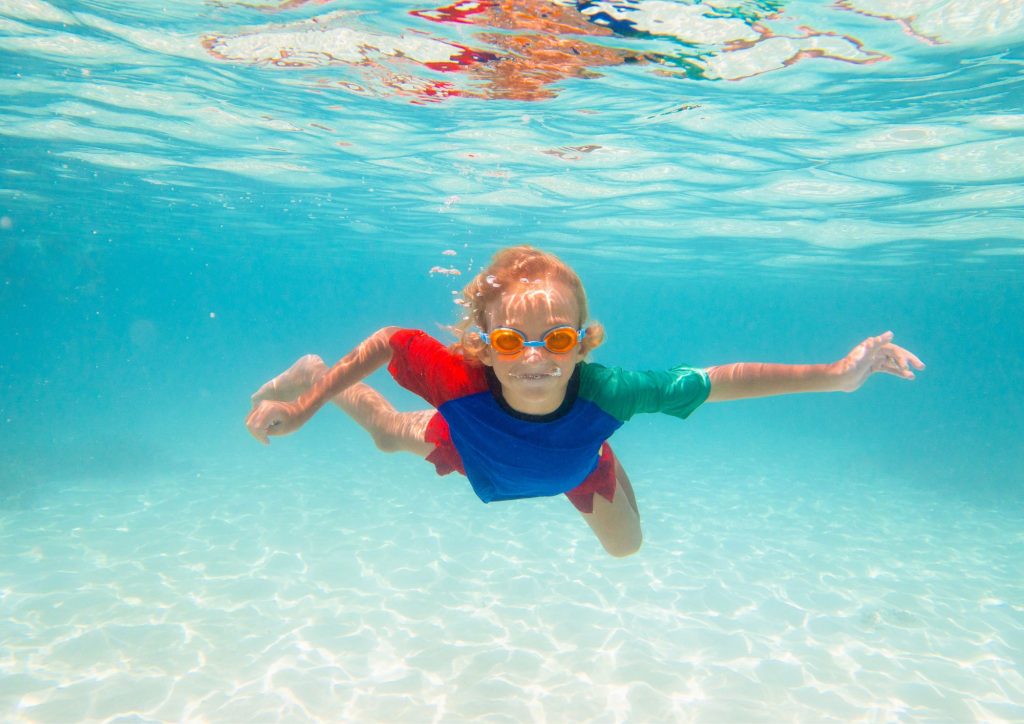 enfant qui nage sous l'eau dans la piscine